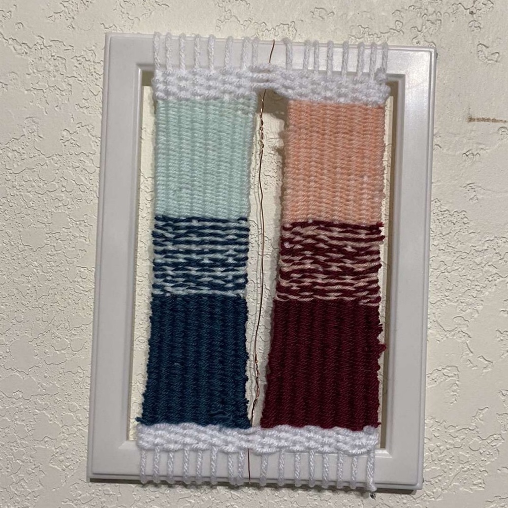 homemade wall hanging in white frame